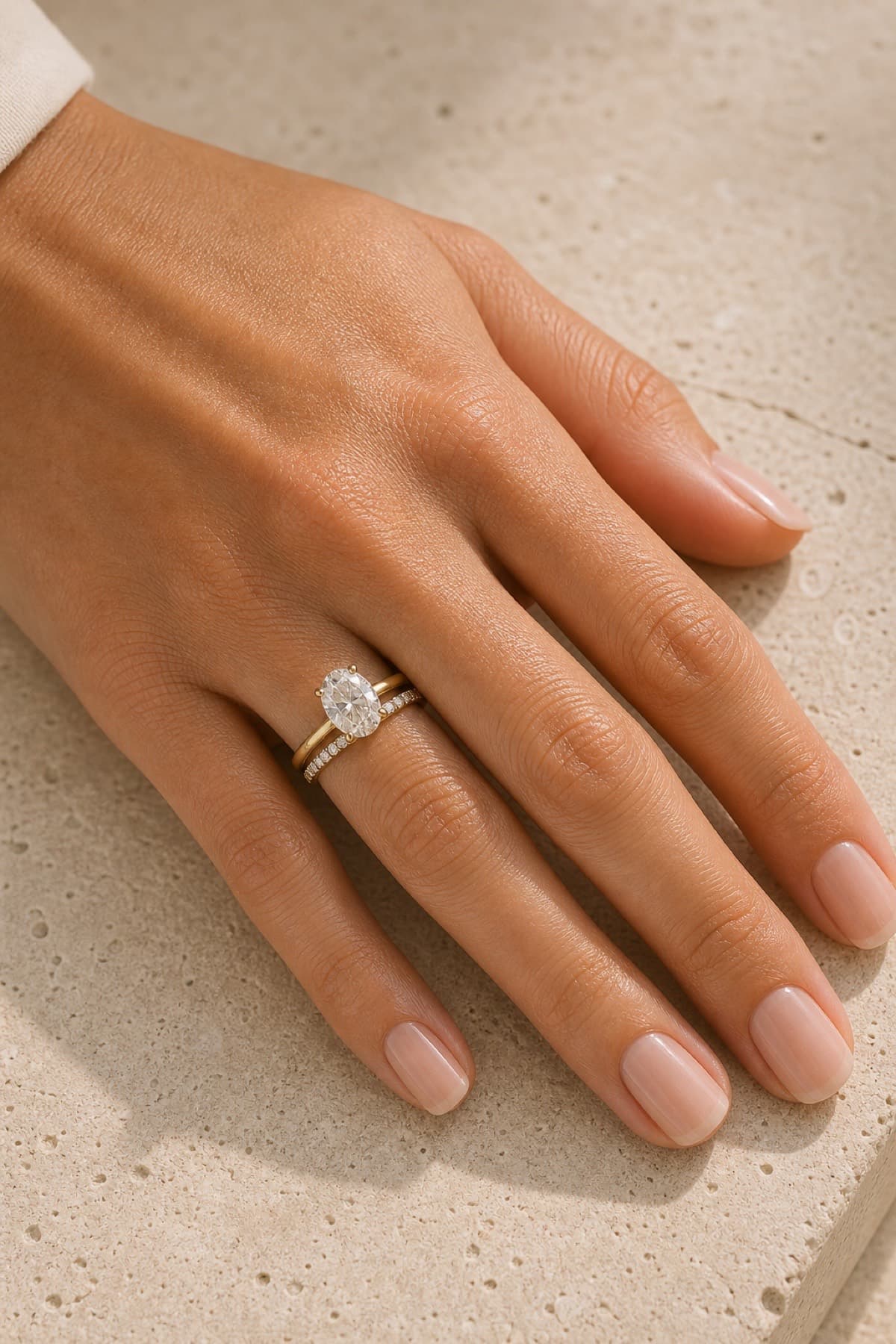 Custom wedding band and engagement ring stack on a woman's left hand ring finger